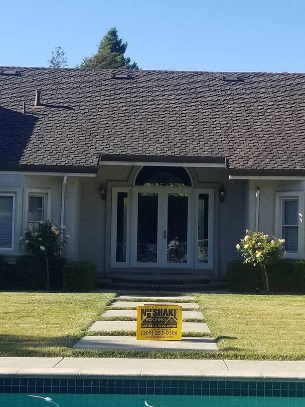 NuShake Roofing yard sign in front of a Livermore, CA home with a completed new roof and gutters