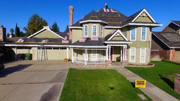 NuShake Roofing roof replacement on a two-story Ripon, CA home, yard sign in front yard