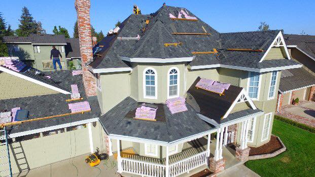 NuShake Roofing crew installing shingles on a two-story Ripon, CA home with a turret roofline