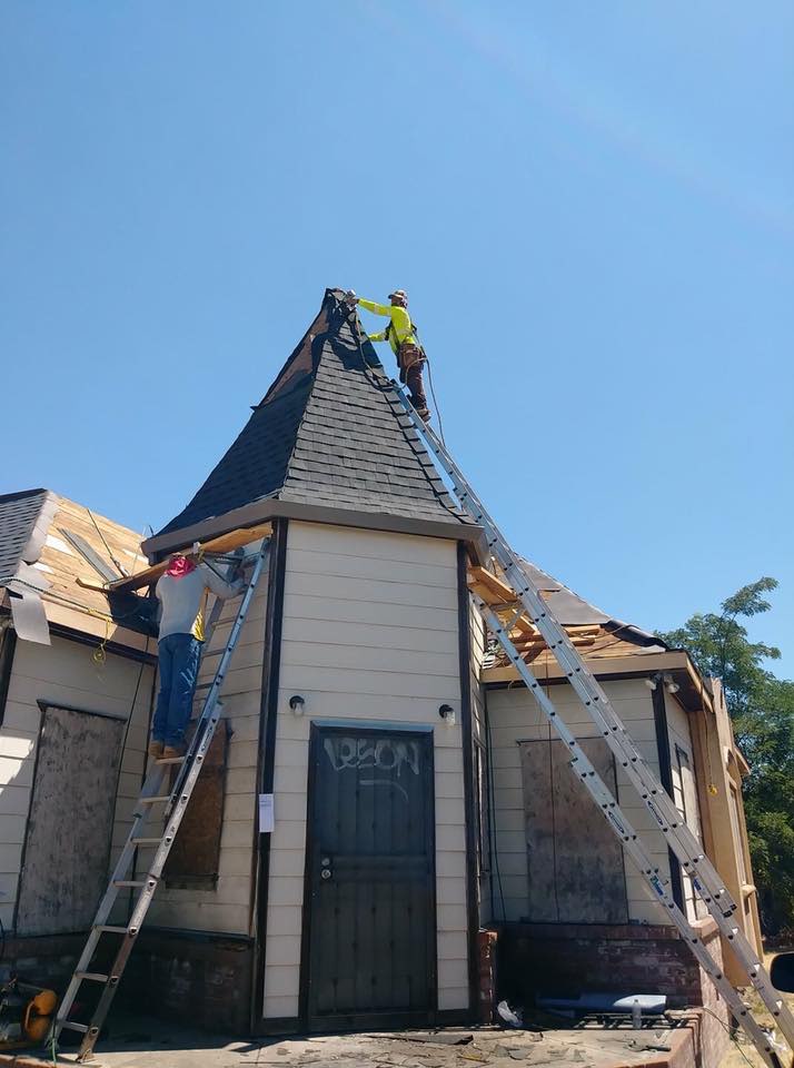 NuShake Roofing crew in safety harnesses on a steep turret roof, Victorian home, Stockton, CA